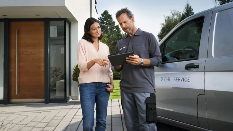 bosch installer with customer in front of car