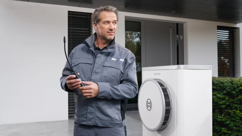 bosch installer with customer in front of car