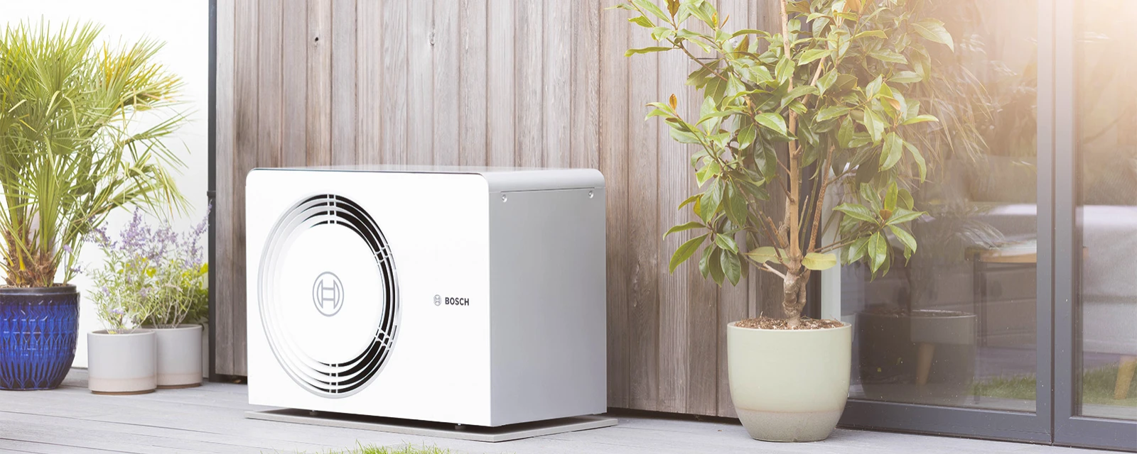 Bosch Compress 5800/6800i AW heat pump standing on house wall