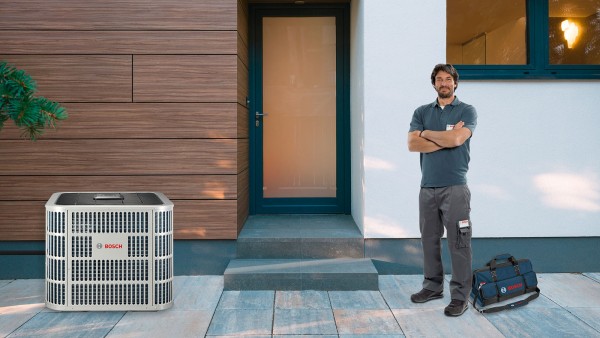 Installer and Bosch Inverter Ducted Split System (IDS) in front of home