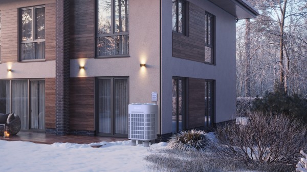 Bosch IDS Ultra cold climate heat pump sits outside of a modern home on a snowy day.