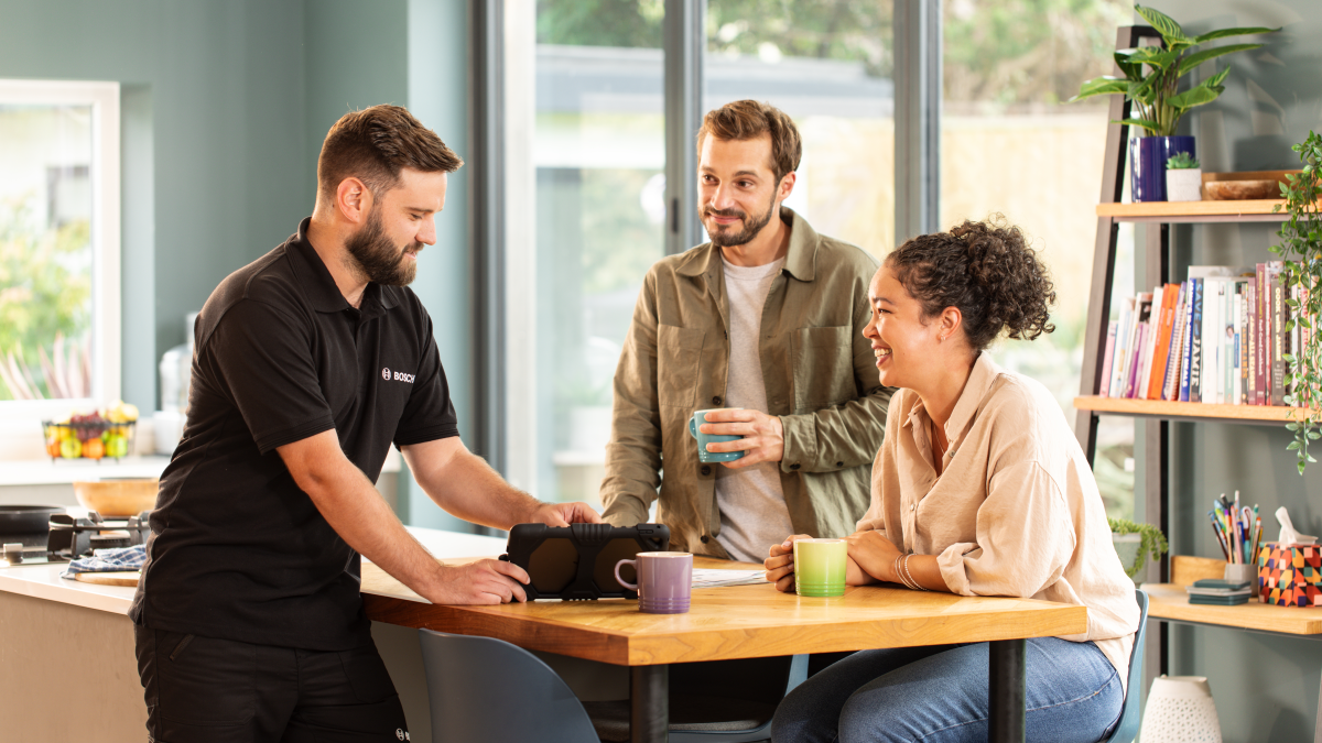 Installer with clients at a table Installer with clients at a table