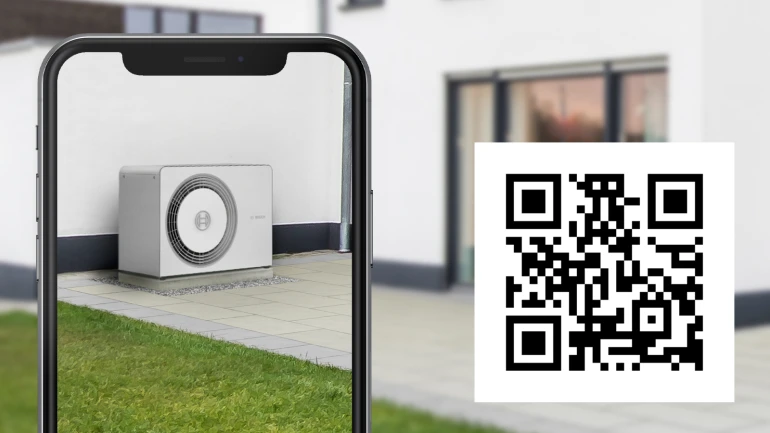 Osoba naskenovala QR kód pro 3D simulaci tepelného čerpadla pomocí svého chytrého telefonu a může si tak virtuálně vyzkoušet požadované tepelné čerpadlo na zahradě.
