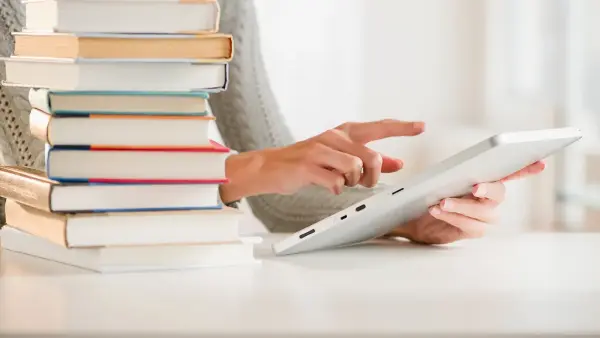 woman_with_books_and_a_tablet