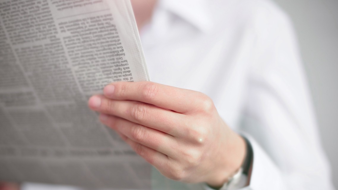 person reads a newspaper person reads a newspaper