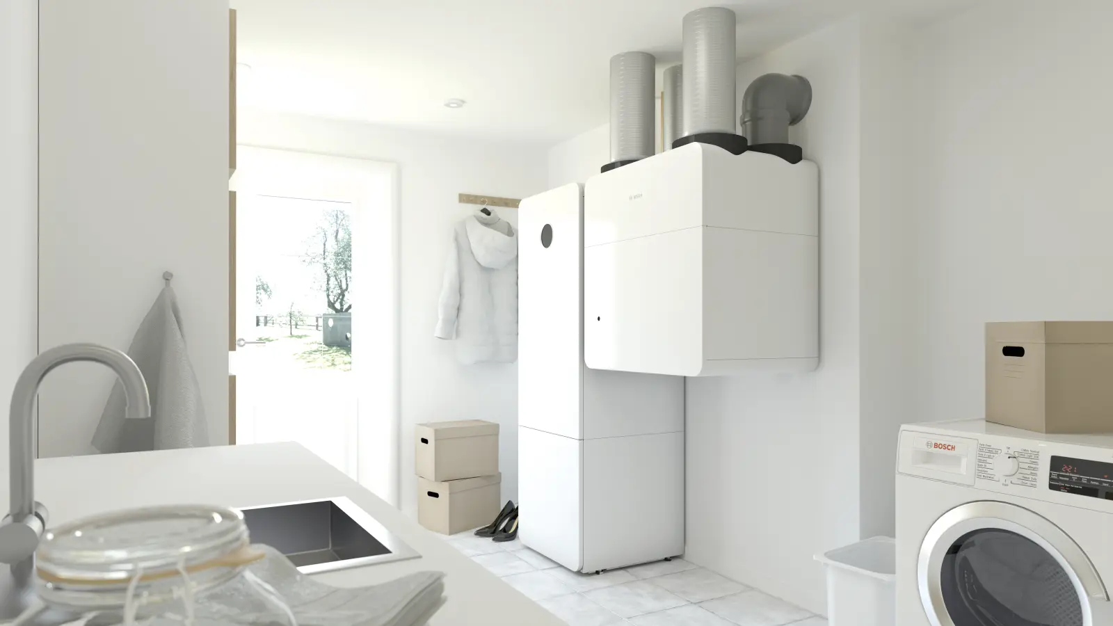 Perfekt integriert in den modernen Hauswirtschaftsraum: Die bodenstehende Inneneinheit der Bosch Wärmepumpe und die zentrale Wohnraumlüftung Vent 5000 C vereinen Heizung, Kühlung und frische Luft in einem nahtlos aufeinander abgestimmten System.