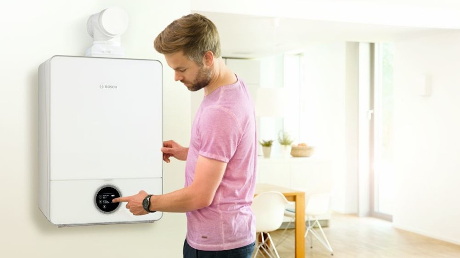 Ein Mann überprüft seine Gastherme Ein Mann überprüft seine Gastherme