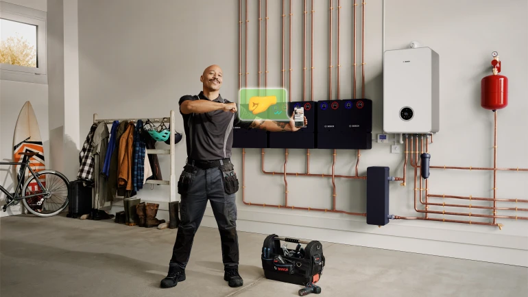 Installer in front of boiler Install Like a Bosch