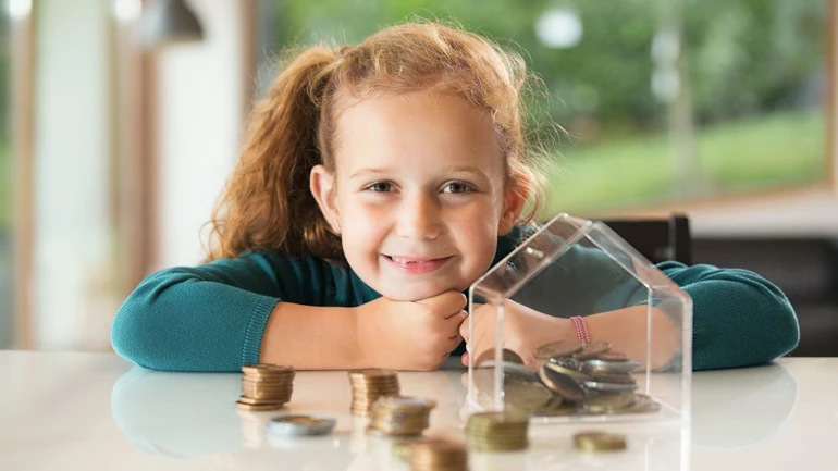 Girl with coins on a table