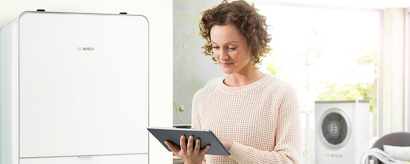 The owner of an air-source heat pump checks her costs on her tablet.
