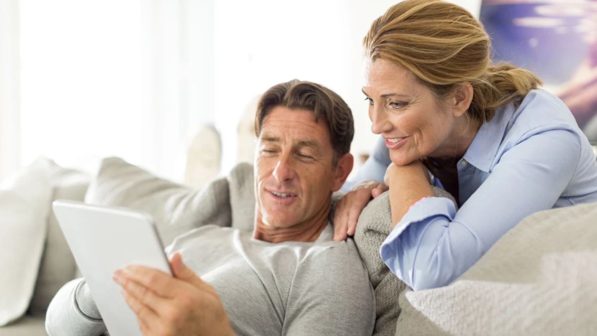 Man and woman look at a tablet