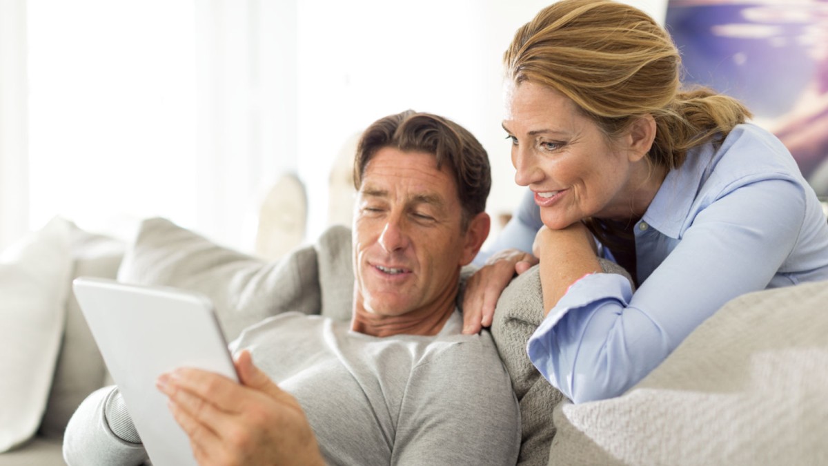 Man and woman look at a tablet Man and woman look at a tablet