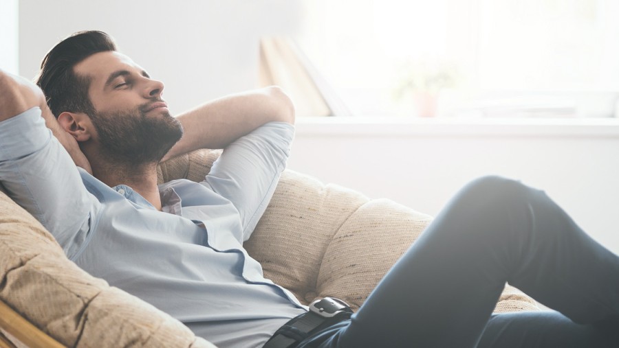 A man sits on an armchair.