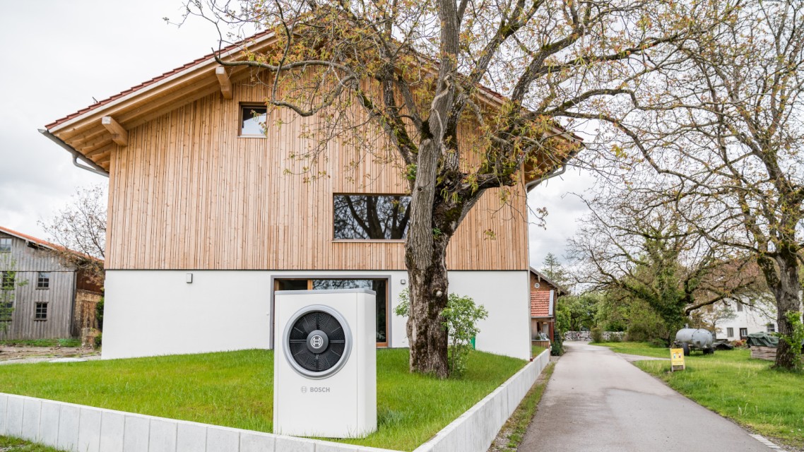 Heat pump in front of a house Heat pump in front of a house