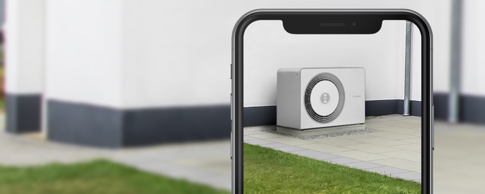 Visualisation en réalité augmentée d'une pompe à chaleur Bosch Compress 5800i AW installée devant une maison individuelle Visualisation en réalité augmentée d'une pompe à chaleur Bosch Compress 5800i AW installée devant une maison individuelle