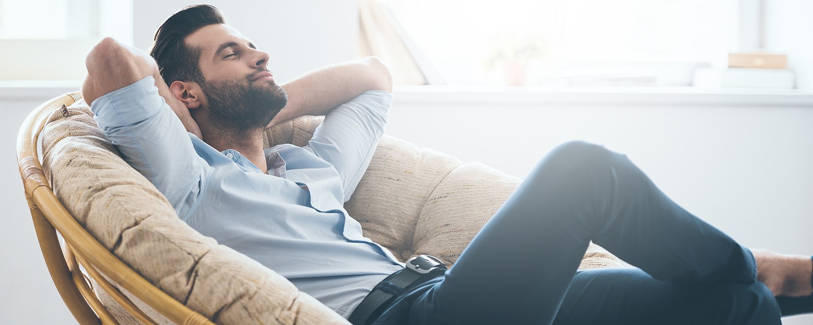 Man leans on a chair.