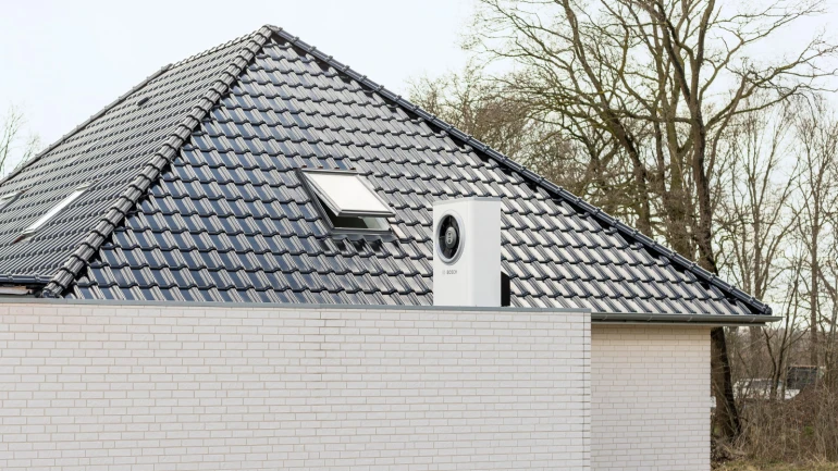 Air-water heat pump is installed on the roof of a new building.