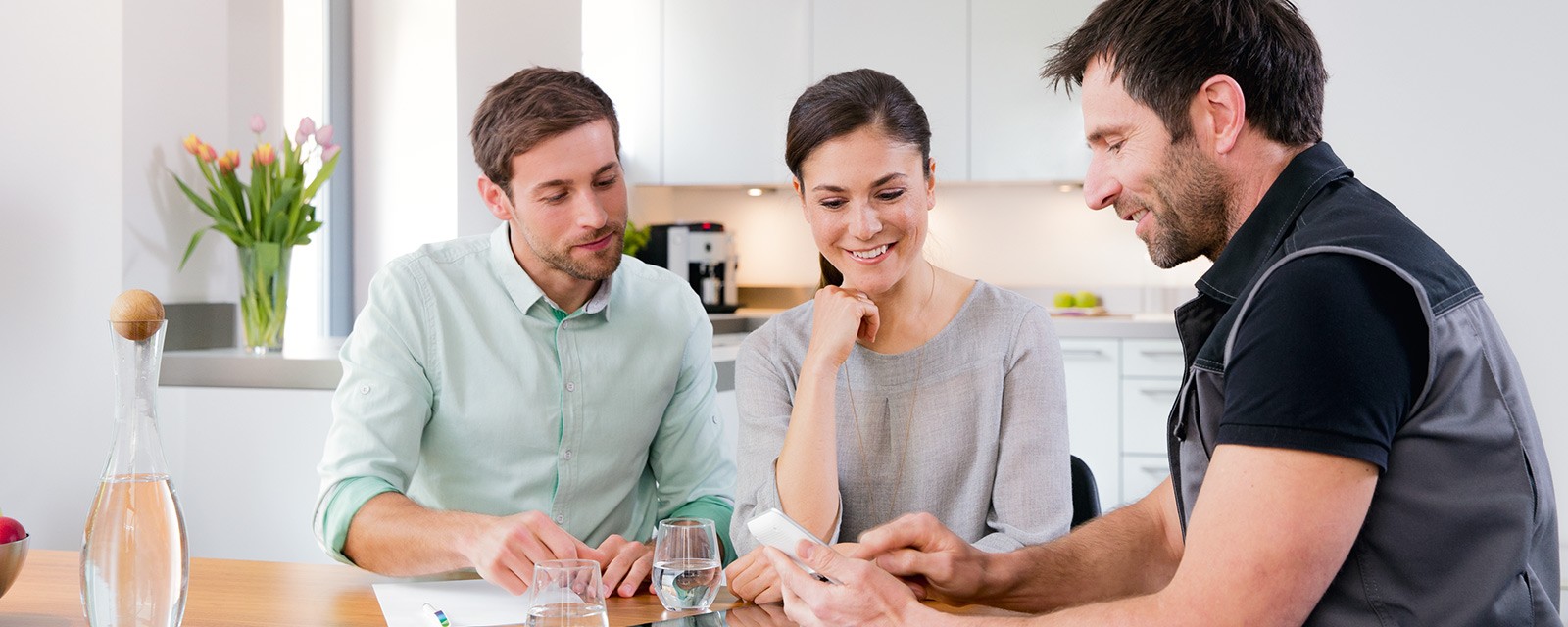 Installer with couple at table Installer with couple at table