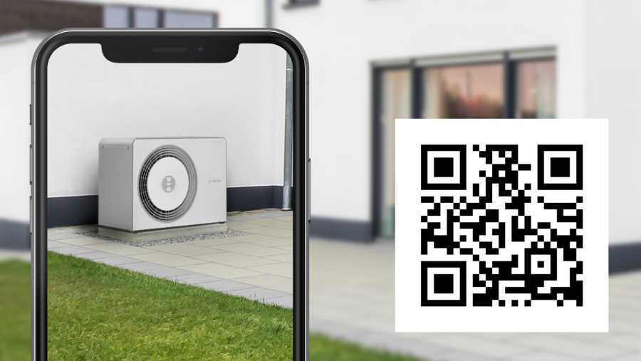 Person has scanned the QR code for the 3D heat pump simulation with her smartphone and can thus virtually experience the desired heat pump in the garden.