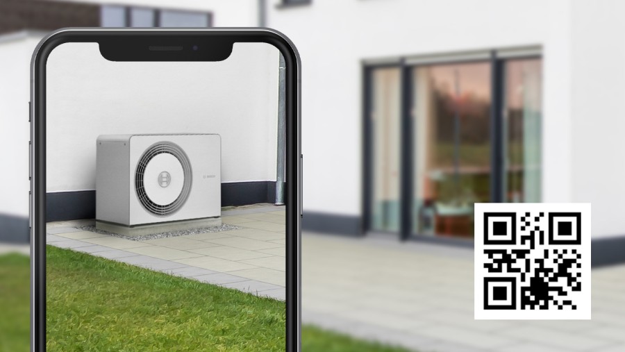 Person has scanned the QR code for the 3D heat pump simulation with her smartphone and can thus virtually experience the desired heat pump in the garden. Person has scanned the QR code for the 3D heat pump simulation with her smartphone and can thus virtually experience the desired heat pump in the garden.