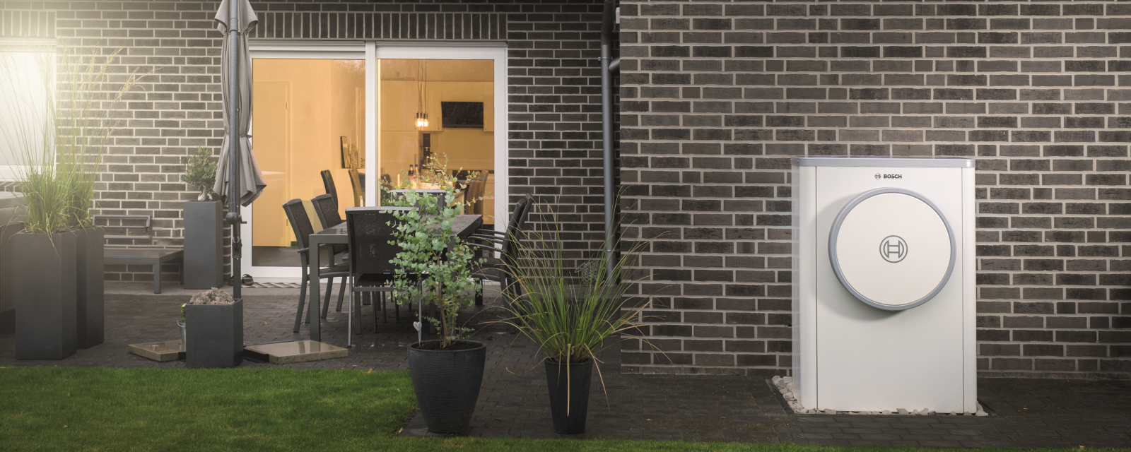 Bosch Compress 7400i AW heat pump standing on house wall Bosch Compress 7400i AW heat pump standing on house wall