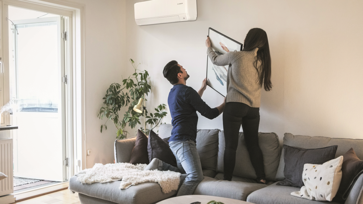 Couple hanging a picture