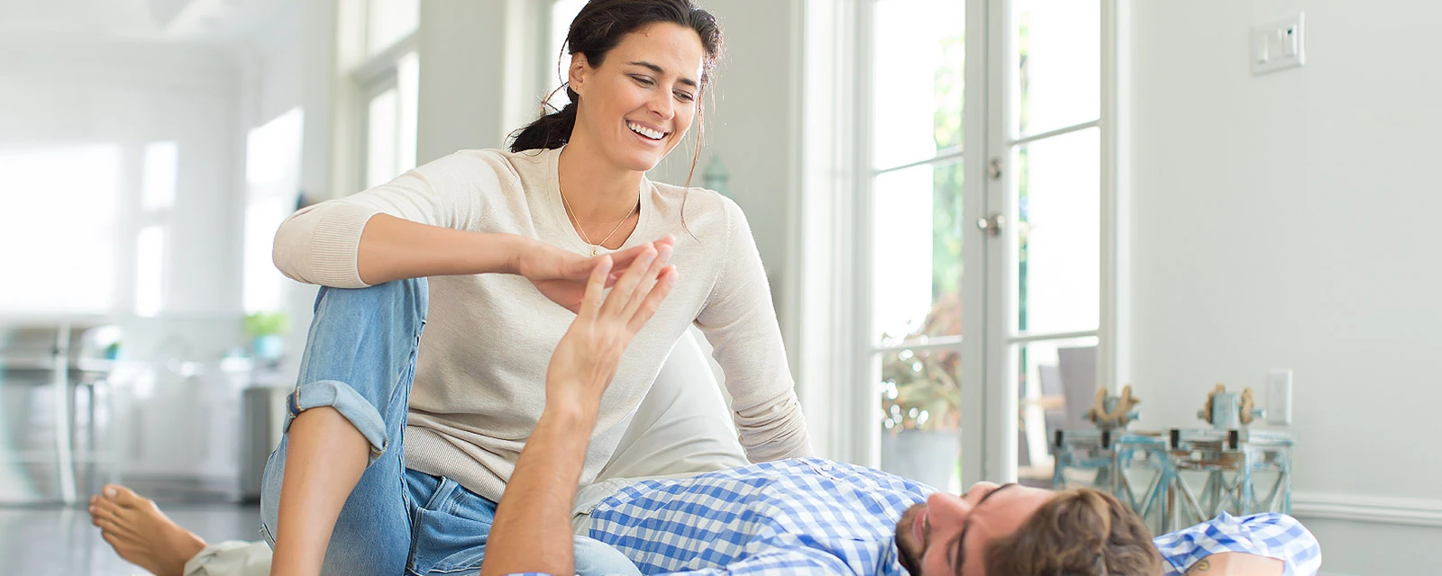 A young couple enjoys their togetherness in a modern living room.