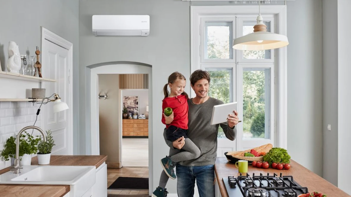 Man with child standing in the kitchen