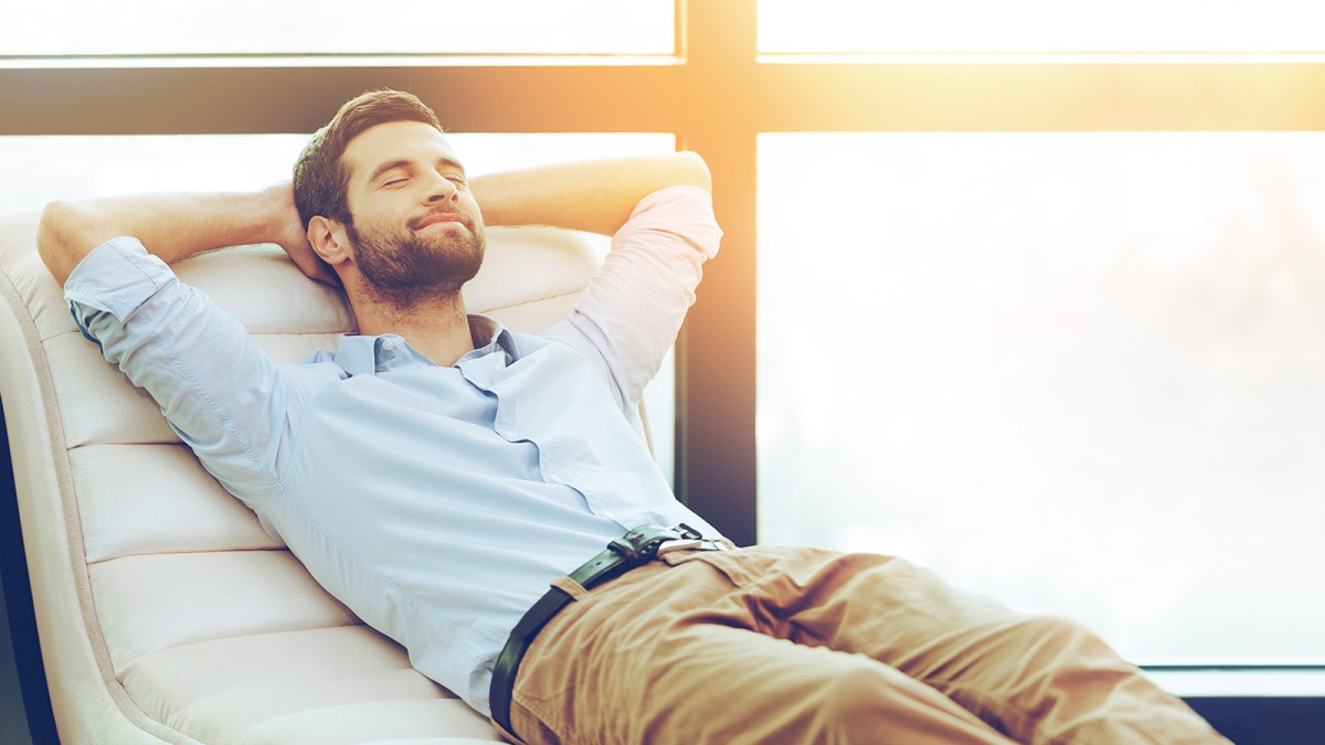 man reclines on sofa man reclines on sofa