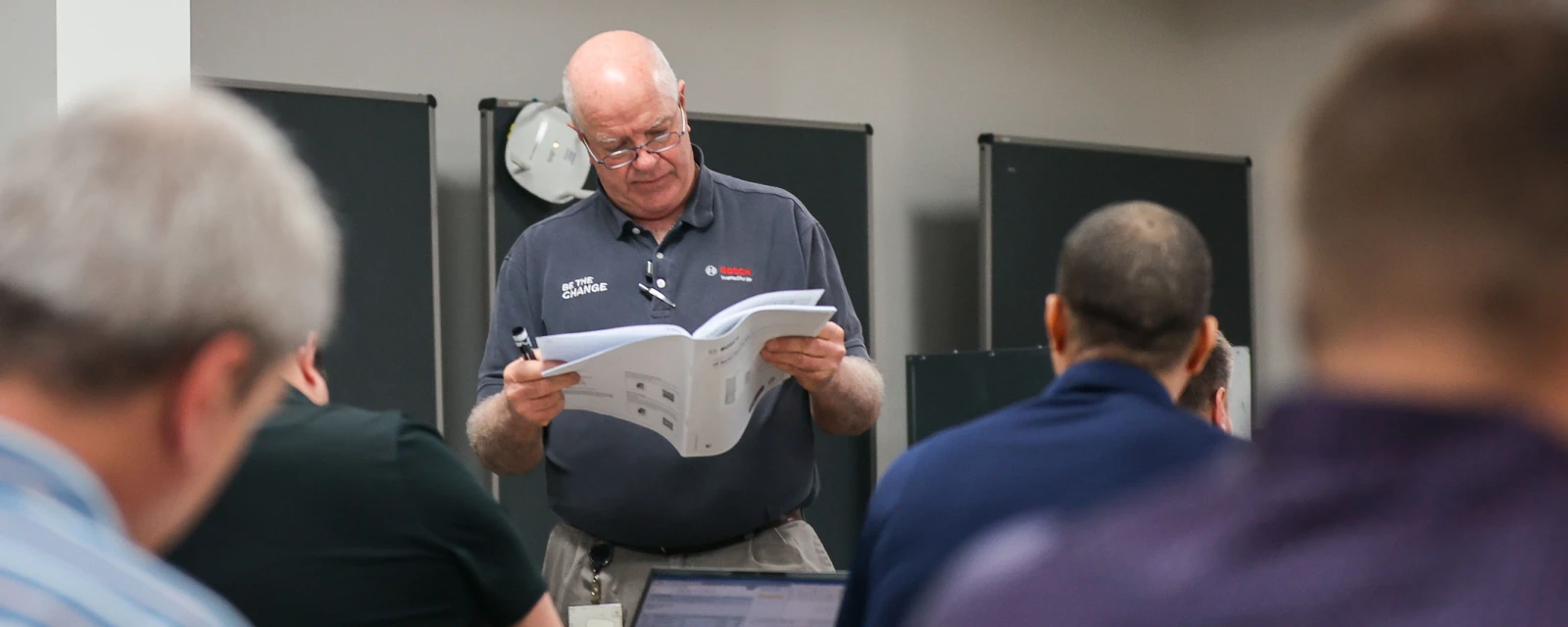Bosch factory training instructor in front of class.